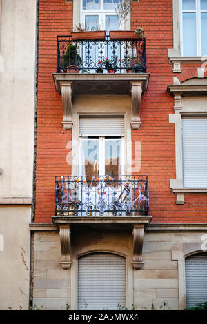 Beautiful French balcony decorated with little pumpkins and fake spider net during Halloween holiday Stock Photo