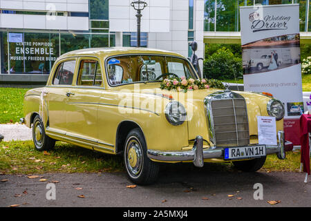 BADEN BADEN, GERMANY - JULY 2019: yellow MERCEDES-BENZ PONTON W180 220S sedan 1954 1959, oldtimer meeting in Kurpark. Stock Photo