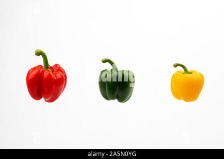 Green  red and yellow sweet peppers on the white background isolated Stock Photo