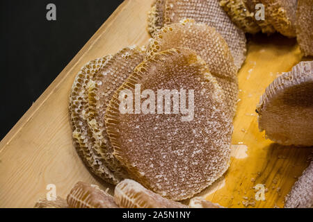 Honey in honeycomb from round beehive with sweet honey Stock Photo