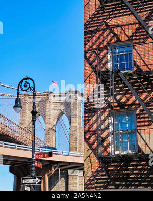 Brooklyn Bridge Stone Tower View and a Typical House with Fire Escapes, Manhattan, New York Stock Photo