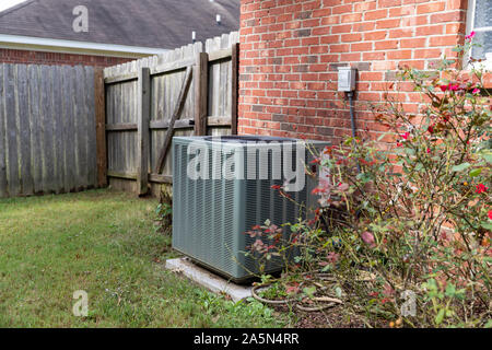 Air Conditioner system next to a home Stock Photo