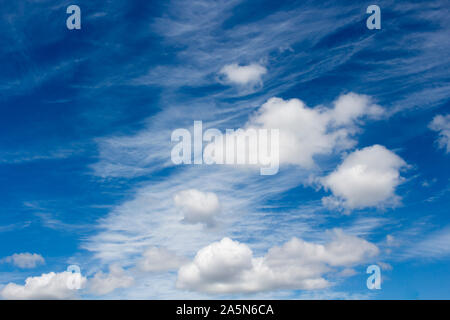 High white wispy cirrus cirro-stratus clouds in a blue Australian sky  sometimes called mare's tails indicate fine weather now but storms coming soon. Stock Photo