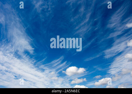 High white wispy cirrus cirro-stratus clouds in a blue Australian sky  sometimes called mare's tails indicate fine weather now but storms coming soon. Stock Photo