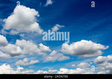 Fluffy white cumulus  cumulostratus cloud formations on a spring afternoon are contrasted against the azure blue Australian sky with a dreamy theme. Stock Photo
