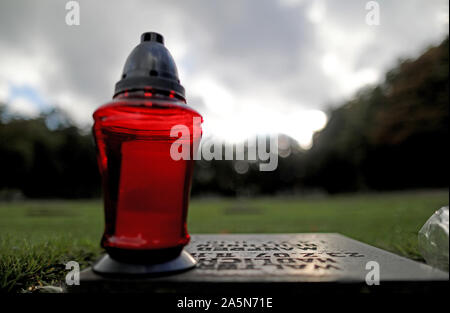 30 September 2019, North Rhine-Westphalia, Hürtgenwald: A light stands on a gravestone at the military cemetery near Vossenack. In the autumn of 1944 one of the cruellest battles of the Second World War raged in the Eifel, in the Hürtgenwald. (to dpa-story: 75 years of battle in the Hürtgenwald) Photo: Oliver Berg/dpa Stock Photo