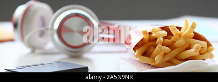 French fries with headphones lying on Stock Photo