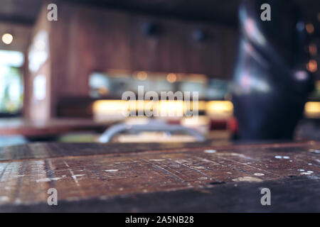 Vintage wooden table with blur bokeh background on cafe Stock Photo