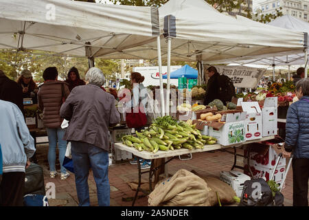 Boston, Massachusetts - October 3rd, 2019: People shopping for fresh produce and local goods at a farmers market in Copley Square on a Fall day. Stock Photo