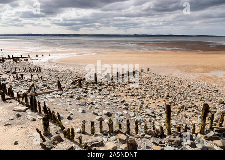 Decaying groynes on the beach at Llanfairfechan, North Wales Stock Photo