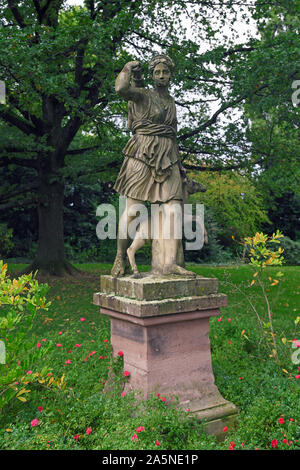 Weinheim, Germany - October 2019: Sculpture of roman goddess of the hund, moon and nature Diana reaching for a quiver in palace garden in city Weinhei Stock Photo