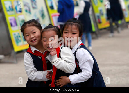 (191022) -- LUOTIAN, Oct. 22, 2019 (Xinhua) -- Students play during class break at Hope primary School in Luotian County, central China's Hubei Province, Oct. 11, 2019. Fang Rong, 29, is the headmaster of Hope primary school of Luotian County, her alma mater. Born in a poverty-stricken region, Fang Rong was a left-behind girl. Thanks to the Hope Project and people's aids, she succeeded in graduating from a secondary normal school. To help more children and repay people's kindness, she decided to be a teacher at her alma mater. In spite of the austere way of life, Fang shouldered her respo Stock Photo