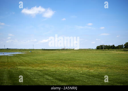 flat northern indiana farmland fields in grass with indication of small flooding indiana USA Stock Photo