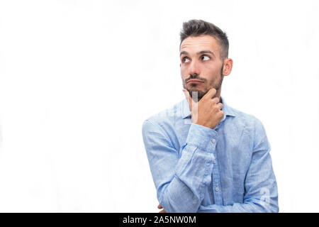 Young isolated man thinking over a white background Stock Photo