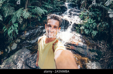 Happy young man take a selfie on a excursion in the forest at summe Stock Photo