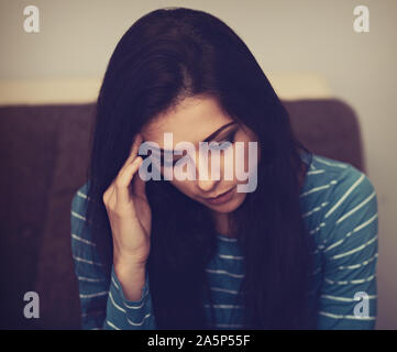 Unhappy woman with headache sitting near the laptop. Closeup portrait of business person on work. Hard day Stock Photo