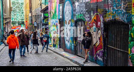 Tourists taking photographs and Instagram photos of graffiti and street art in Hosier Lane Melbourne Victoria Australia. Stock Photo