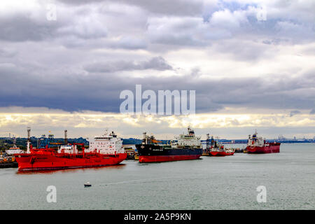 Shipping moored at Fawley Refinery in Hampshire, viewed when leaving Southampton Harbour, England, UK. Stock Photo