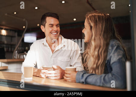 Friends smiling and laughing in a cafe - having a great time together Stock Photo