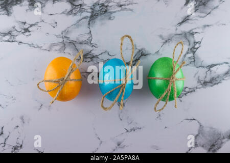 Marble Easter flat lay background with painted Easter eggs. Place for text. Stock Photo