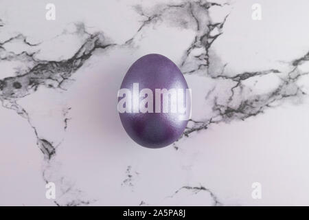 Marble Easter flat lay background with painted Easter egg. Stock Photo