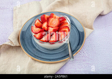 Strawberry Custard, Pudding with strawberry over wooden background. Stock Photo