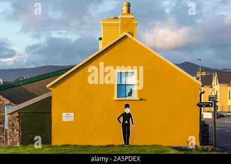 Yellow house with figure of Charlie Chaplin, Waterville, County Kerry, Ireland Stock Photo
