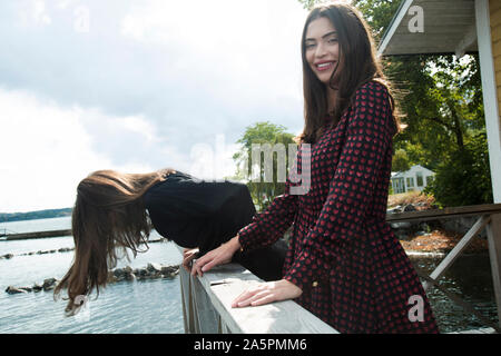Young women standing on balcony Stock Photo