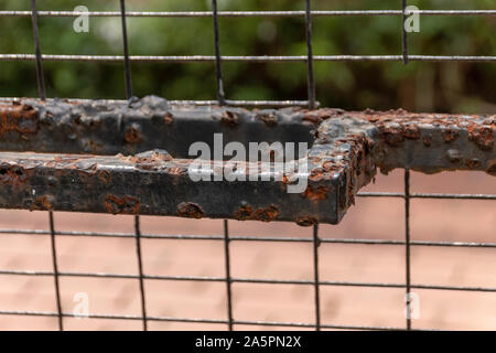 A close up view of a rusted handel on a wire gate Stock Photo