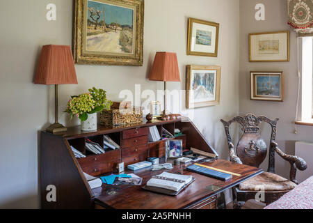 Writing desk and pair of lamps with antique carved wooden chair. Stock Photo