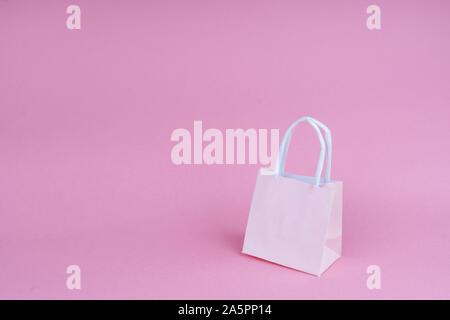 Paper shopping or gift bags on pink background with copy spaсe. Concept sales, shopping, black friday. Giving gift for birthday, christmas and New Yea Stock Photo