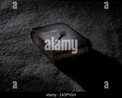 Key On Top Of Open Holy Bible Stock Photo