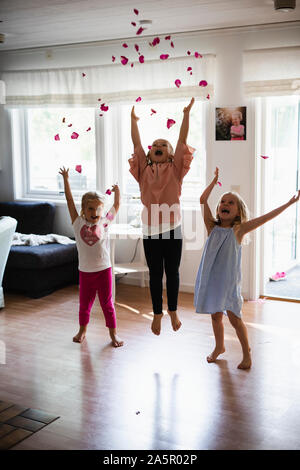 Happy girls throwing rose petals Stock Photo - Alamy