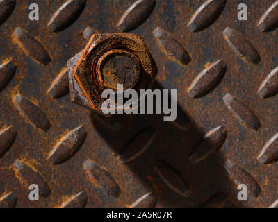 Rusty Bolt and Metal Diamond Plate Detail Stock Photo