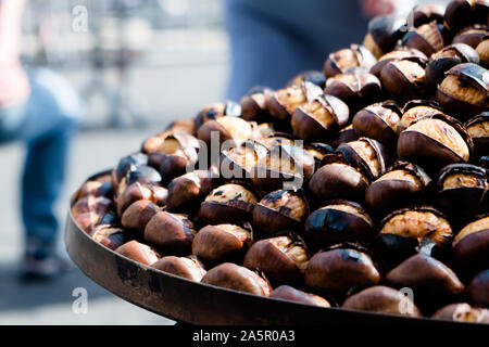 closeup of some roasted chestnuts on sale in a street food stand in Rome, Italy Stock Photo