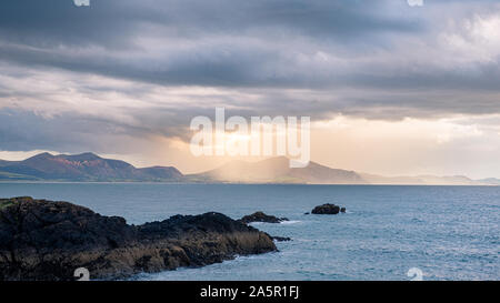 View of the llyn peninsula from Ynys Llanddwyn on Anglesey, North Wales at sunset.