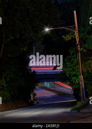 Solitary Street Light With Highway Overpass In Background Stock Photo