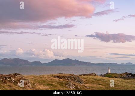 The Llanddwyn island lighthouse, Goleudy Twr Bach at Ynys Llanddwyn on Anglesey, North Wales at sunset.