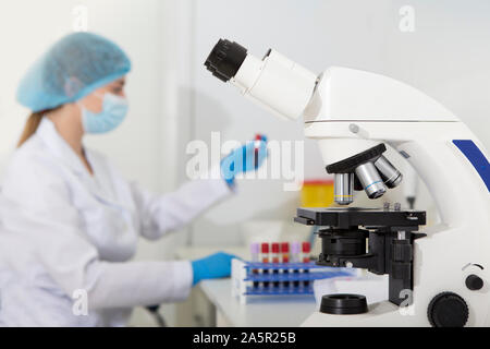 Woman researcher in laboratory testing samples on white blood cells Stock Photo