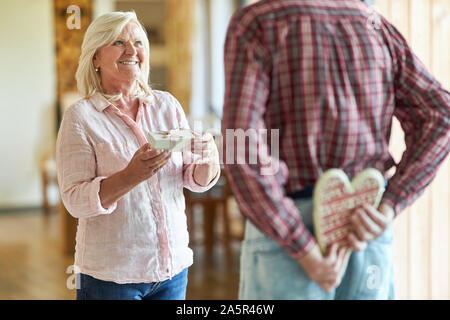 Senior woman is happy about a gift from her husband or boyfriend Stock Photo