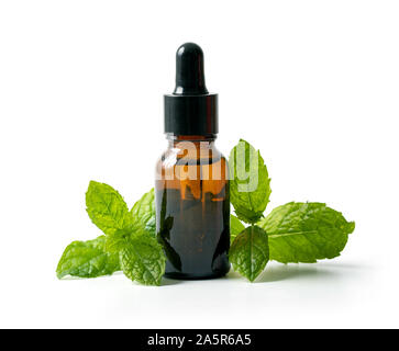 bottle with mint essential oil and green leaf isolated on white background Stock Photo