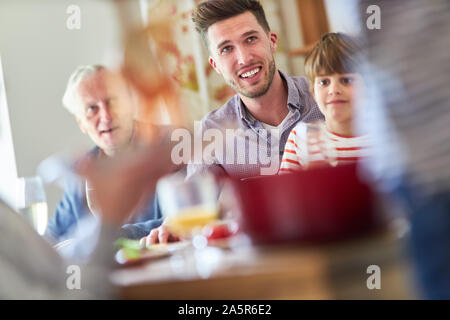 Happy family with children and grandparents having spaghetti meal Stock Photo