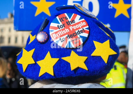 London, UK - 22 October 2019. An Anti Brexit protester wearing a hat with the stars of the European Union  demonstrates outside the gates of Parliament as the government faces opposition  to pass the Withdrawal Agreement Bill within the deadline of 31 October  Credit: amer ghazzal/Alamy Live News Stock Photo