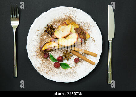 Christmas cake with cinnamon rolls anise star rasberry, apple cake Stock Photo