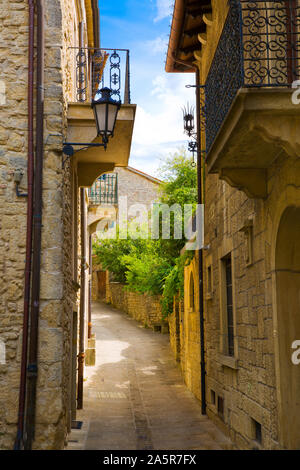 San Marino medieval street, old vintage lantern on the walls. Medieval walls from bricks and stones. Stock Photo