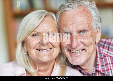 Senior couple smiling happily at the camera Stock Photo