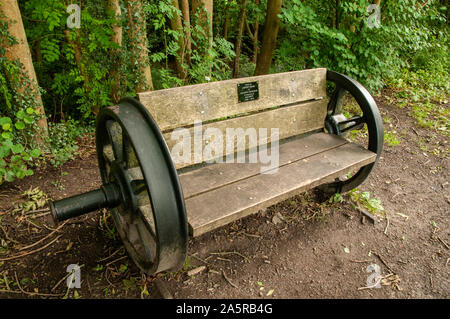 A bench made by Andrew Izzard from a train wheel set placed on the Cuckoo Trail, a disused railway line between Hampden Park and Heathfield, East Suss Stock Photo