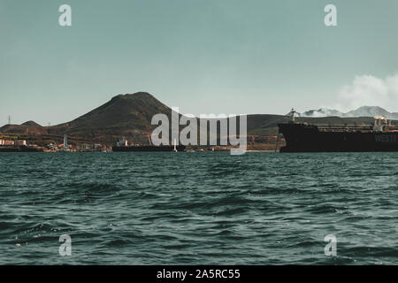 Freighters pass through de busy por of La Paz BCS Stock Photo