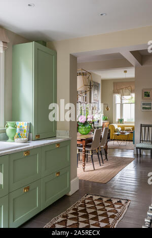 Green fitted units in open plan Victorian terrace renovation Stock Photo