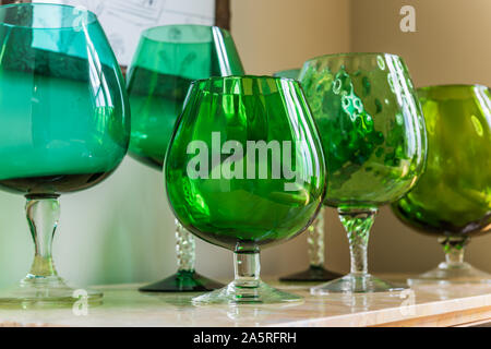Vintage green glassware on antique sideboard. Stock Photo
